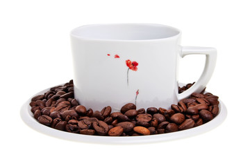 White cup with coffee beans on saucer.