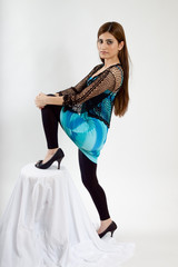 Fototapeta premium Lovely woman with her foot on a chair