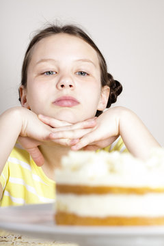 girl looking at cake