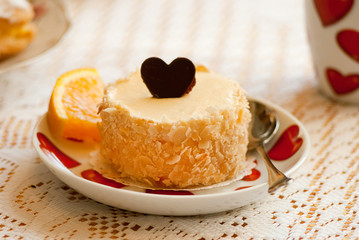 Love cheesecake with chocolate heart and orange slice