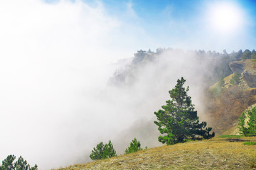 Mountain between clouds.