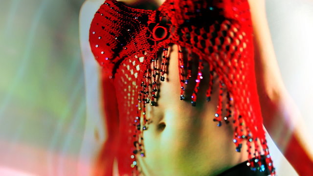 beautiful young blond woman dances in oriental style red top