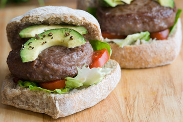 Angus beef burgers on wooden board