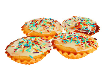 Four cakes with colorful decoration.
