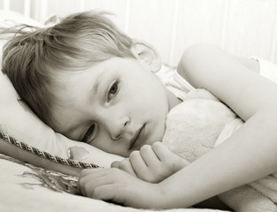 Sad child in bed