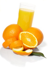 Orange juice and oranges on a white background.
