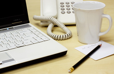 Office desk with notebook, telephone and memo notes