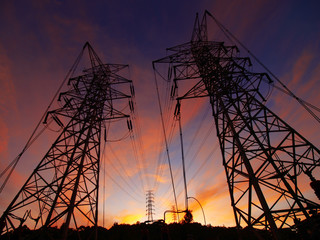 Sunset and electric towers in high mountain