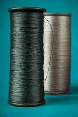 large spools of thread on a blue background