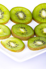 Fototapeta premium Kiwi slices on white plate