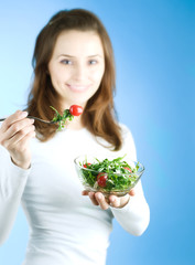 Dieting Concept.Happy Young Woman eating vegetable salad