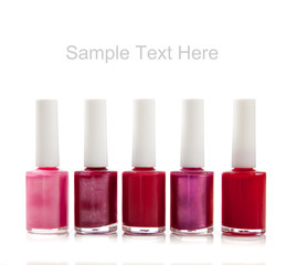 Assorted fingernail polish on a white background with copy space