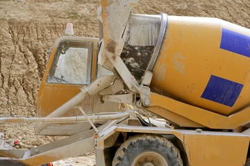 Concrete mixer truck detail in yellow with blue stripes