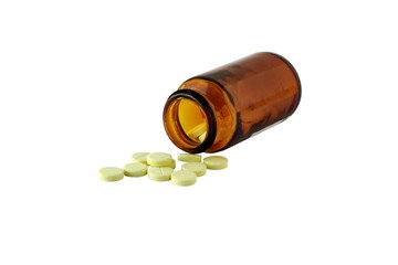 The vitamins scattered from a bottle as tablets