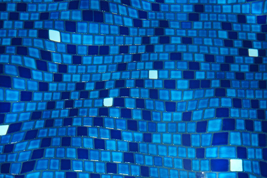 Background image of swimming pool tiles refracted by the water