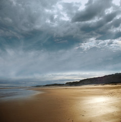 Fototapeta na wymiar Stormy beach with dark clouds
