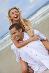 Fototapeta na wymiar Man and Woman Couple Having Fun On A Beach