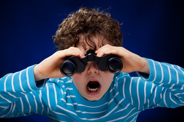 Boy looking through binocular