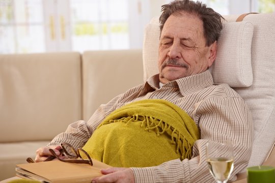 Senior man sleeping in armchair
