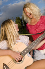Mothers and daughter playing music © pauldimarco