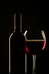 Bottle of red wine and glass
