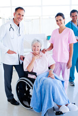 Serious medical team taking care of a senior woman