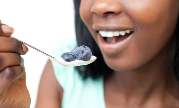 Close-up Of A Woman Eating A Yogurt With Blueberries