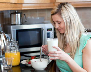 Charming woman having an healthy breakfast in a kitchen