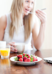 Obraz na płótnie Canvas Cute woman having an healthy breakfast