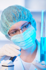 Female researcher holding up a test tube