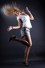 Fototapeta na wymiar woman modern dancer against black background