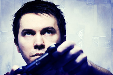 Man with gamepad playing videogame. Blue tint.