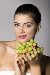 Woman with fresh green grapes