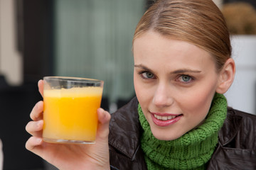 young woman with a glass of orange juice