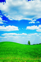 green hill and clouds on sky