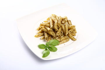 Penne with pesto decorated with basil