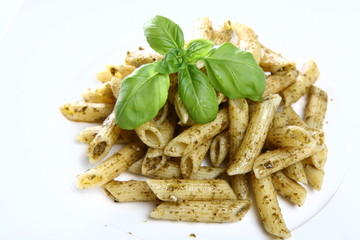 Penne with pesto decorated with basil