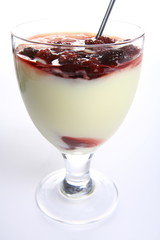 Pudding dessert with raspberries and a spoon