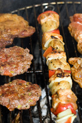 Meat and skewers on the grill