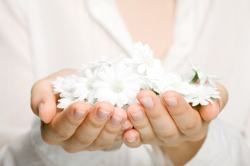Woman holding white flowers