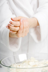 ÊCloseup of beautiful female hands applying hand cream