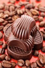Chocolate and coffee beans on red background