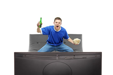 Excited man watching sport on a TV isolated on white background
