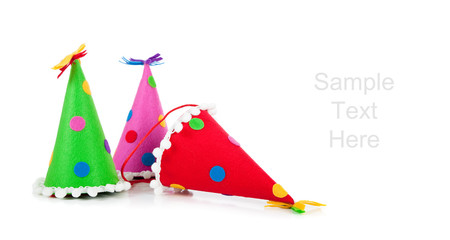Polka-dot birthday hats on a white background