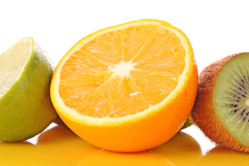 Orange and other fruits on yellow
