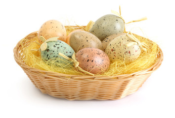 Easter eggs in basket on white background