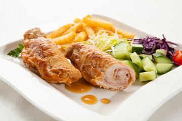Roasted stuffed pork chop with chips and vegetables