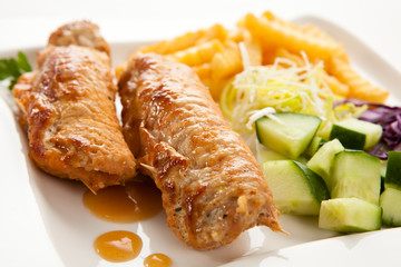 Roasted stuffed pork chop with chips and vegetables