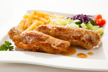 Roasted, stuffed pork chop with chips and vegetables