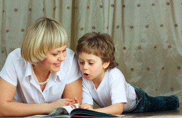 woman and little boy reading book